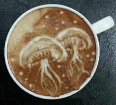 a cappuccino with an intricate design on it