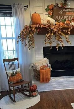 a living room filled with furniture and a fire place covered in pumpkins on top of a mantel