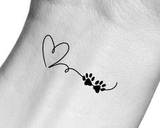 a dog paw with a heart tattoo on it