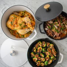 three pans filled with food on top of a white marble countertop next to plates and utensils