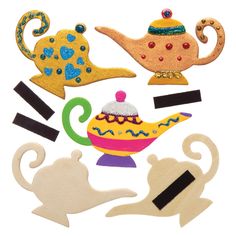 wooden cutouts with teapots and cats on them