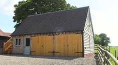 two wooden garages sitting next to each other