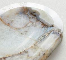 a white marble plate sitting on top of a table