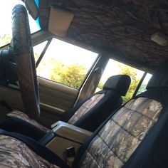 the interior of a car with camo seat covers and matching headrests is shown