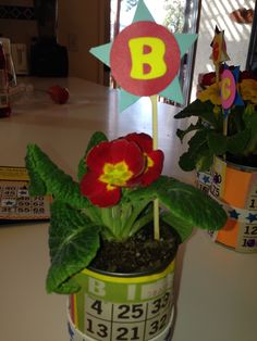 a potted plant with a flower in it and a sign that says b on top