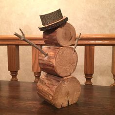 a stack of logs sitting on top of a wooden table next to a hat and wrench