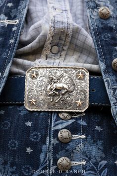 WHOA COWBOY! The stunning silverwork present in this piece is truly something to behold. This bold statement buckle boasts intricate scroll engraving and a detailed dimensional bucking bronc in the midst of a sterling silver shield. Four 10k gold fill stars were placed in the corners giving it the exact details it needed. A buckle like this one can be added to any belt to complete any outfit. hallmarks: Double D Ranch materials: sterling silver, 10K gold fill measurements: 3 1/2" x 2 1/2" weight Scroll Engraving, Cowboy Belt Buckles, Collar Tips, Double D Ranch, Cowboy Belt, Cashmere Accessories, Stocking Gifts, Vintage Horse, Jewelry Pins