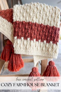 a crocheted blanket sitting on top of a wooden chair with tassels