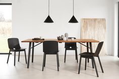 a dining table with four chairs in front of it