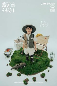 a little boy in a hat and vest standing on top of a green patch of grass