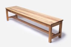 a wooden bench sitting on top of a white floor