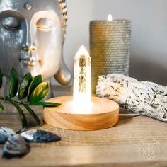 a candle that is sitting on top of a table next to some plants and other items