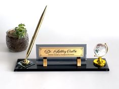 a desk with a pen, globe and other items on it in front of a white background