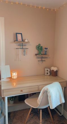 a bedroom with a desk, chair and shelves on the wall next to each other