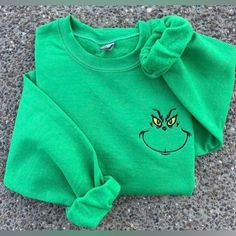 Embroidered Grinch Face Crewneck Holiday Sweatshirt Go Up One Size For Oversized Fit Standard Women Sizing Cricut Crew Neck Sweatshirt, Christmas Embroidery Sweatshirts, Embroidered Shirt Ideas, Embroidery Designs Sweatshirt, Grinch Smile, Christmas Sweatshirt Ideas, Green Lighting, Cozy Clothing, Grinch Face