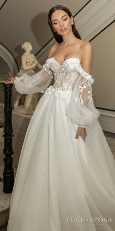 a woman in a white wedding dress posing for the camera