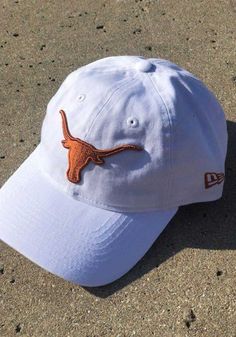 This Texas Longhorns White Adjustable Hat features a front embroidered team logo on a lightly structured crown with pre-curved visor and adjustable strapback. New Era 9TWENTY, Front embroidered team logo, 6-panel crown design with eyelets, Fabric self strap, Adjustable Closure, Cotton material, Cotton, Washable, 4 Collegiate Baseball Hat With Curved Brim, Collegiate Baseball Cap With Curved Brim For Baseball Season, Collegiate Adjustable Dad Hat For Baseball Season, Collegiate Adjustable Dad Hat With Curved Visor, Curved Brim Snapback Hat With Embroidered Logo For College, Dad Hat With Embroidered Logo For Fan Gear, Embroidered Logo Dad Hat For Fan Gear, Fan Gear Dad Hat With Embroidered Logo, Game Day Embroidered Logo Snapback Dad Hat