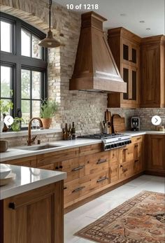 a kitchen with wooden cabinets and an area rug in front of the stove top oven