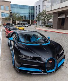 the bugatti supercar is parked in front of a building