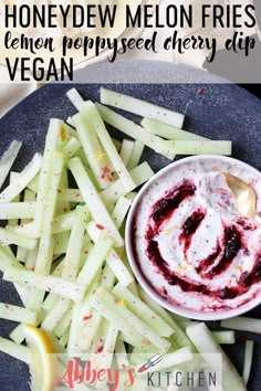 a blue plate topped with fries next to a bowl of dip