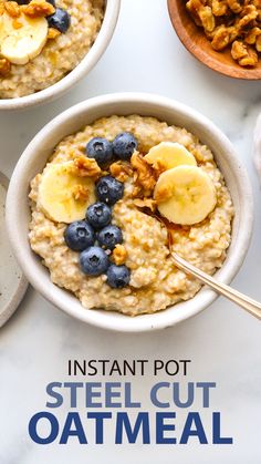 two bowls filled with oatmeal topped with bananas and blueberries next to nuts