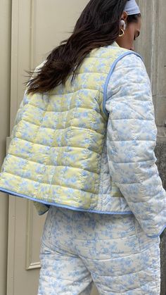 Made from recycled fabric, our lightweight Amelia Quilted Jacket features a colorblock design of our original toile floral prints. Designed as a convertible piece, the Amelia Jacket can be worn as-is or turned into a vest by removing the sleeves. Butter yellow and off-white base with baby blue florals Soft matte quilted fabric Removable sleeves and functional front pockets Lightweight warmth Made from recycled poly Your order will ship from our warehouse in Florida, USA! Casual Floral Patchwork Outerwear For Spring, Spring Patchwork Outerwear, Spring Nylon Outerwear With Patchwork, Quilted Cotton Outerwear For Spring, Spring Cotton Quilted Outerwear, Spring Quilted Cotton Outerwear, Blue Patchwork Outerwear For Spring, Fitted Nylon Spring Outerwear, Blue Quilted Spring Outerwear