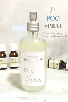 a bottle of poo spray sitting on top of a counter next to other bottles