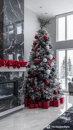 a christmas tree with red and silver ornaments in front of a fireplace decorated for the holidays