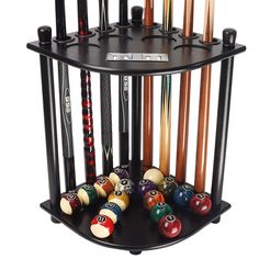 a rack with pool balls and cues in it