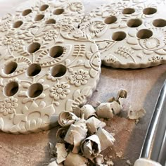 two cookies that are sitting on top of a cookie sheet with holes in the middle