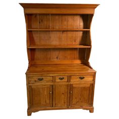 an old wooden hutch with drawers and cupboards