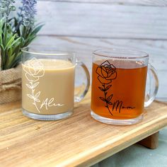 two mugs sitting on top of a wooden table