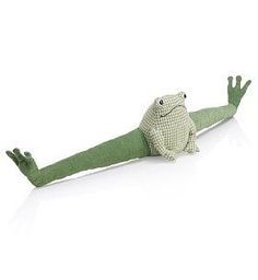 a stuffed frog that is laying down on its back with it's legs spread out