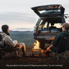 two people sitting in chairs around a campfire