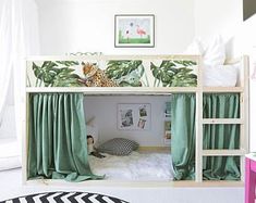 there is a bunk bed with green curtains on it