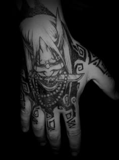 a black and white photo of a person's hand with tattoos on it