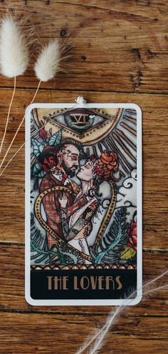 the lovers tarot card on a wooden table