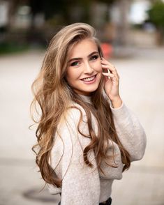 a beautiful young woman talking on a cell phone