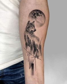 a man's arm with a wolf and pine trees tattoo on the left forearm