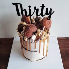 there is a cake that has been decorated with chocolate, nuts and other toppings