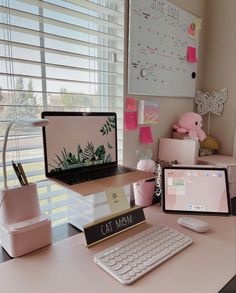 a desk with a laptop, keyboard and mouse on it