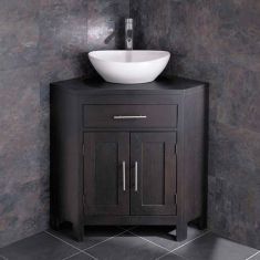 a bathroom sink sitting on top of a wooden cabinet