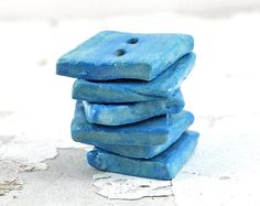 a stack of blue rocks sitting on top of a white surface