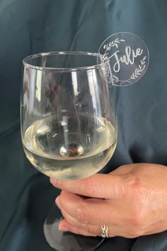 a person holding a wine glass in their hand with the word true written on it