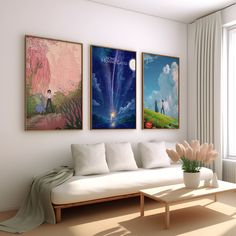 a living room with three paintings on the wall and a white couch in front of it