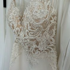 the back of a wedding dress with beading on it