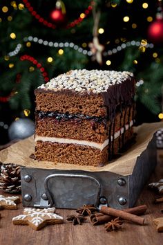 a piece of cake sitting on top of a wooden table next to a christmas tree