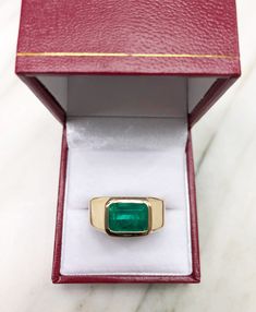 This men's sleek 18K gold ring says it all. This ring is made with our finest, genuine materials from our emerald and diamond collection. The emerald cut gemstone is natural and comes directly from Colombia, a country known for the finest quality emeralds in the world. The gem featured in this ring is of excellent color and very good eye clarity. The emerald is bezel set set in 18K rose gold. The band is smooth and effortless. The ring is comfortable for daily wear.  Setting Style: Solitaire Rin Men Pinky Ring, Colombian Emerald Ring, Columbian Emeralds, Natural Emerald Rings, Green Emerald Ring, Ring Man, Emerald Ring Gold, Ring Men, Men's Wedding Ring