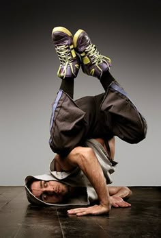 a man is sitting on the floor with his feet in the air while wearing adidas sneakers