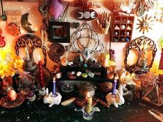 a room filled with lots of assorted items and candles on top of a table